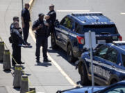 Police stand outside of Garfield High School on Thursday, June 6, 2024, in Seattle.