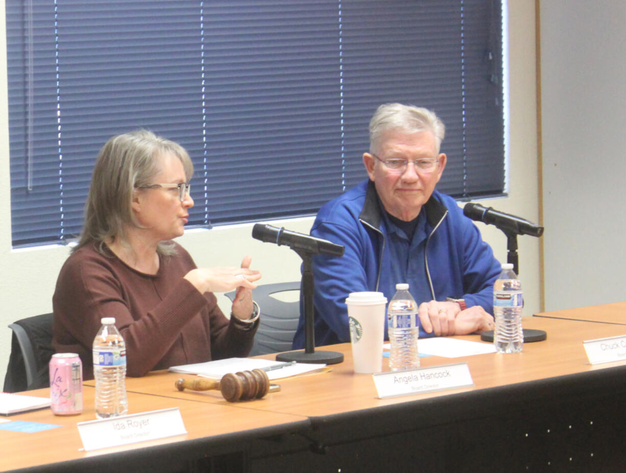 Washougal School Board President Angela Hancock, left, speaks during a school board meeting April 30. Hancock will resign from the board effective June 12.