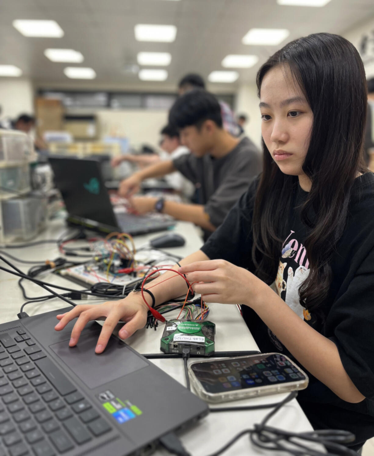 Wei Yu-han, 19, works on her final project in the electronics engineering lab at National Yang Ming Chiao Tung University.