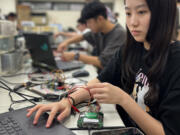 Wei Yu-han, 19, works on her final project in the electronics engineering lab at National Yang Ming Chiao Tung University.