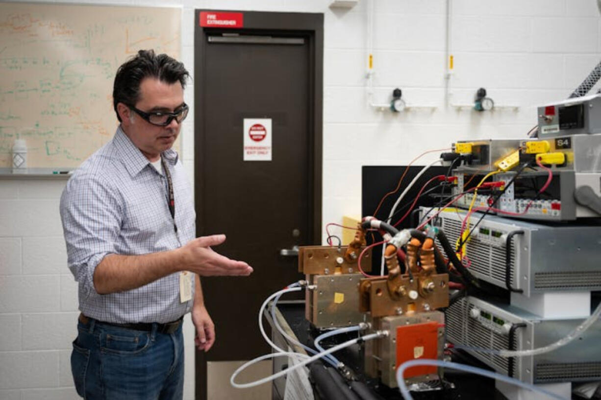 3M scientist Andy Steinbach explains the small-scale electrolyzers that use electricity to separate water into oxygen and hydrogen. The devices were undergoing durability tests to ensure a 3M powder can last as long as it should - in turn driving down costs, a key component for the green hydrogen industry&rsquo;s potential success. (Shari L.