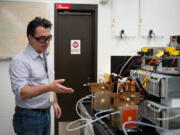 3M scientist Andy Steinbach explains the small-scale electrolyzers that use electricity to separate water into oxygen and hydrogen. The devices were undergoing durability tests to ensure a 3M powder can last as long as it should - in turn driving down costs, a key component for the green hydrogen industry&rsquo;s potential success. (Shari L.