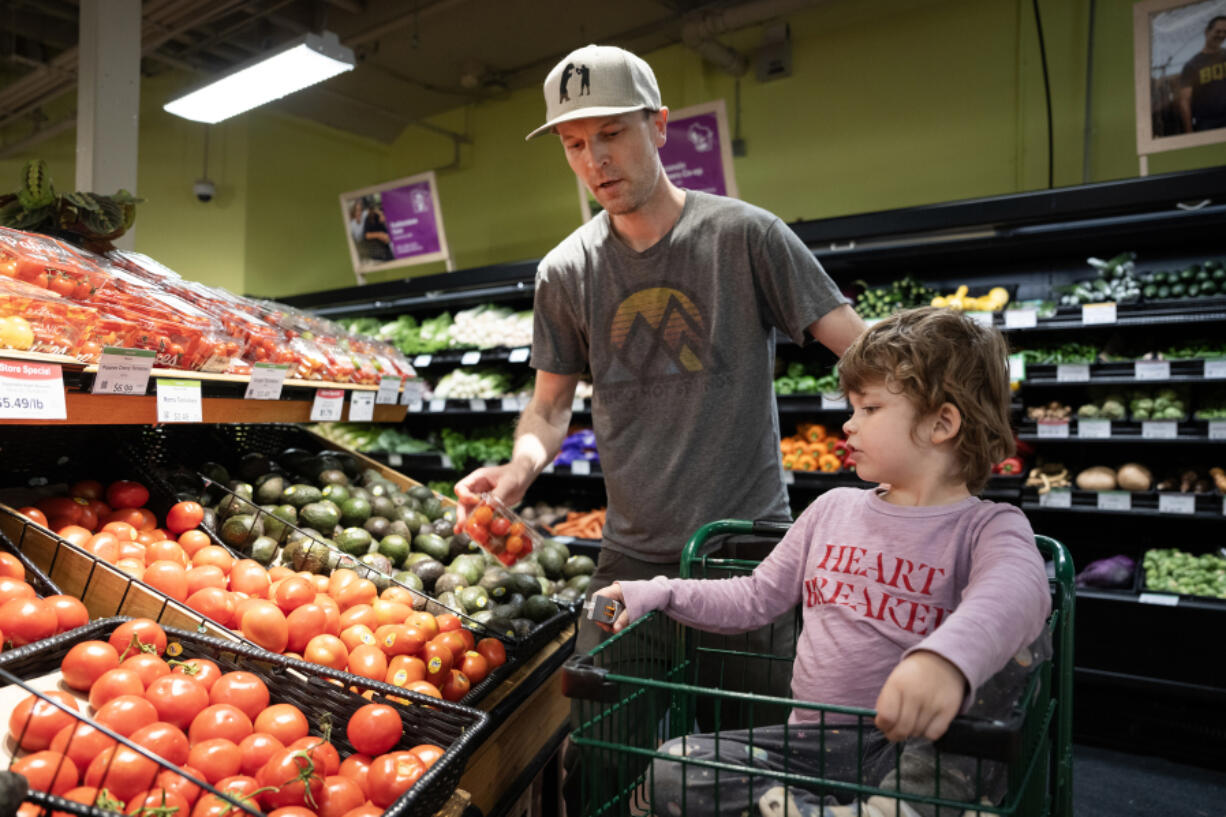 Josh Kohanek and Rudy, 4, pick up groceries May 7 at Seward Community Co-op in Minneapolis. (Shari L.