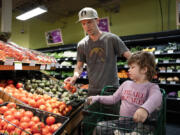 Josh Kohanek and Rudy, 4, pick up groceries May 7 at Seward Community Co-op in Minneapolis. (Shari L.