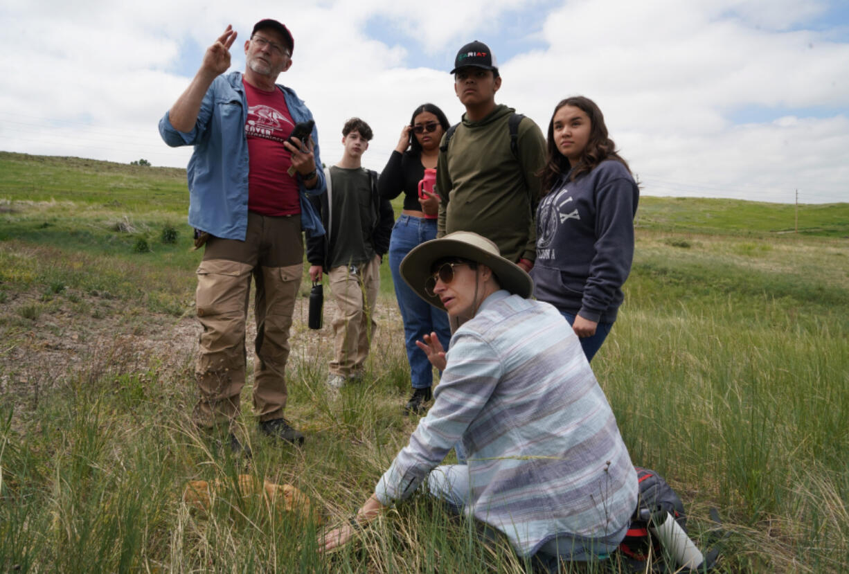 Kent Hups, a science instructor at Northglenn High School, talks May 31 about how to identify dinosaurs by how many toes they had in Broomfield, Colo.