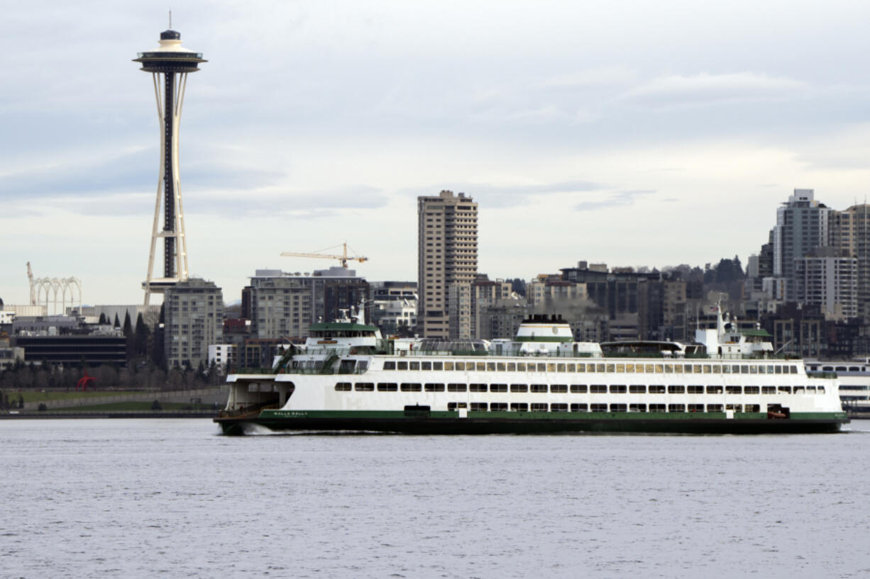 A Washington State ferry travels into Elliott Bay in Seattle on Feb. 17. The ferry system announced a bidding process to build five new hybrid ferries.