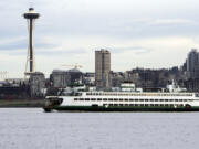 A Washington State ferry travels into Elliott Bay in Seattle on Feb. 17. The ferry system announced a bidding process to build five new hybrid ferries.