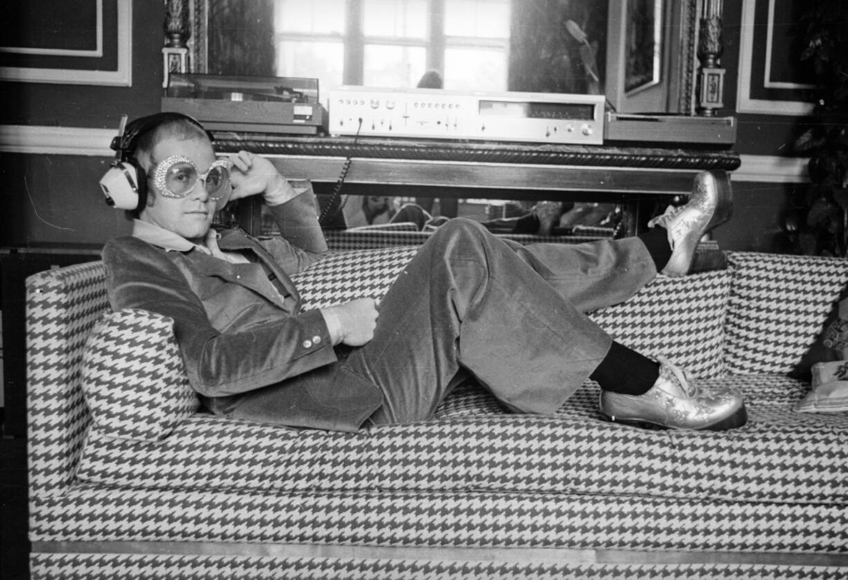 English pop star Elton John relaxes on a sofa and listens to music on Sept. 12, 1974.  His &ldquo;Don&rsquo;t Let the Sun Go Down on Me,&rdquo; topped the charts in summer on 1974 (D.