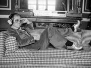 English pop star Elton John relaxes on a sofa and listens to music on Sept. 12, 1974.  His &ldquo;Don&rsquo;t Let the Sun Go Down on Me,&rdquo; topped the charts in summer on 1974 (D.