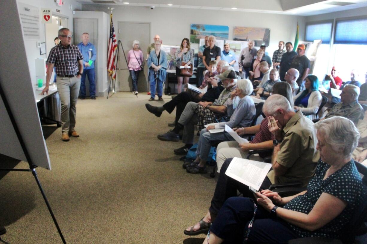 Fern Prairie residents listen to Port of Camas-Washougal CEO David Ripp, left, speak about the port&rsquo;s request to annex its Grove Field properties into Clark County&rsquo;s urban growth boundary during an open house on June 5.