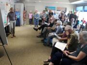 Fern Prairie residents listen to Port of Camas-Washougal CEO David Ripp, left, speak about the port&rsquo;s request to annex its Grove Field properties into Clark County&rsquo;s urban growth boundary during an open house on June 5.