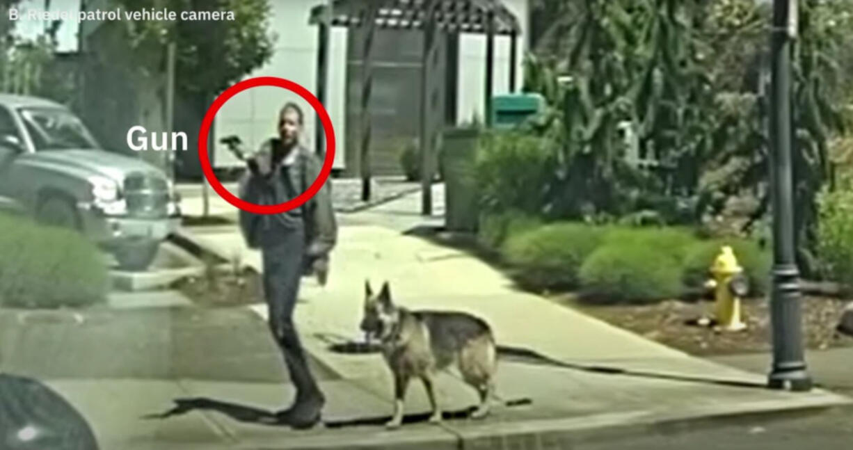 Police video shows a man point what appears to be a gun.