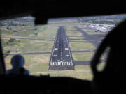 A plane can be seen from the cockpit of a 757 research plane sitting at the beginning of the runway at the airport in Yakima, Washington, on Friday, June 7, 2024. At right is Alaska Airlines pilot Jennifer Kelsey. (Ellen M.