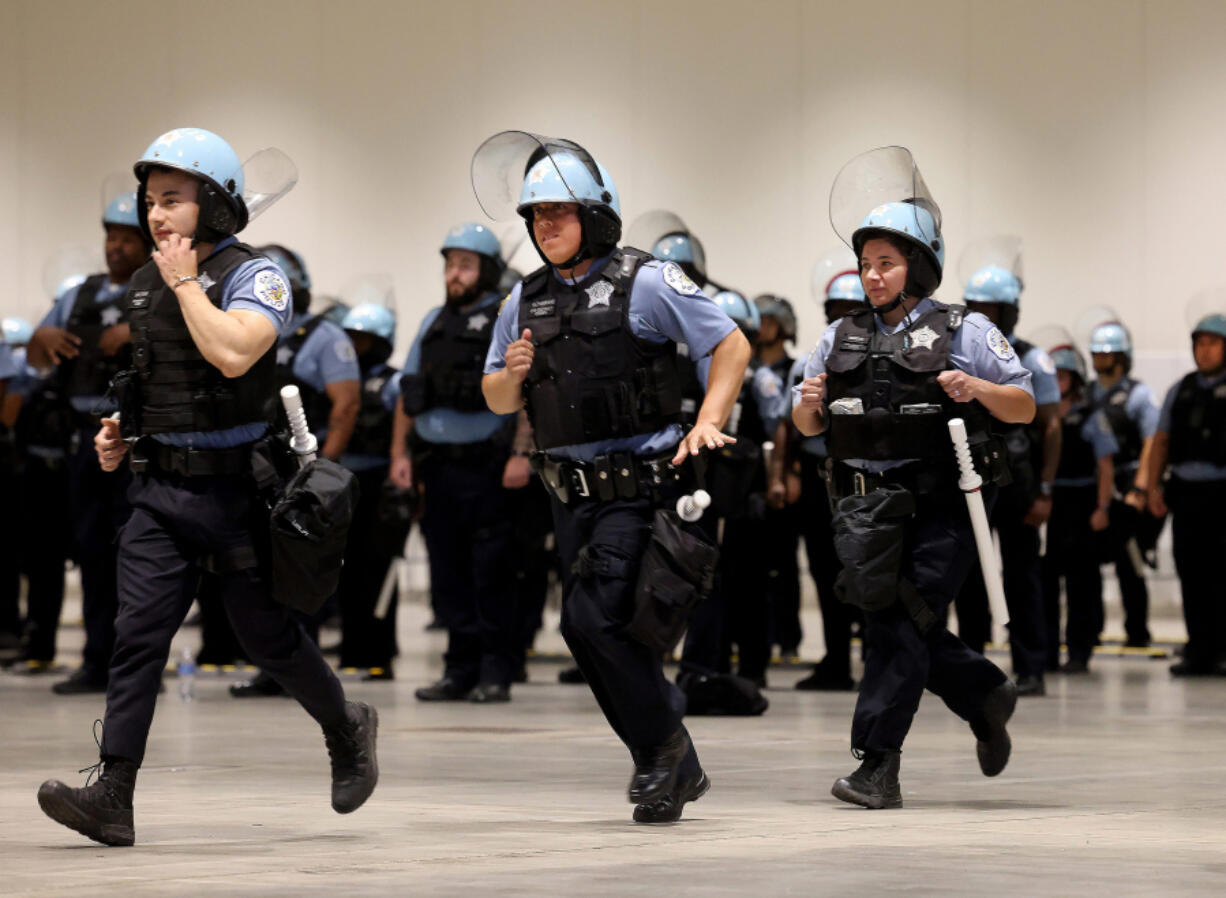 Police officers run in formation as the Chicago Police Department offers a first look at officer training at McCormick Place on June 6, 2024, in preparation for the Democratic National Convention in August. The officers at the training session are among the 2,500 officers who will be on the front lines during the DNC.