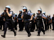 Police officers run in formation as the Chicago Police Department offers a first look at officer training at McCormick Place on June 6, 2024, in preparation for the Democratic National Convention in August. The officers at the training session are among the 2,500 officers who will be on the front lines during the DNC.