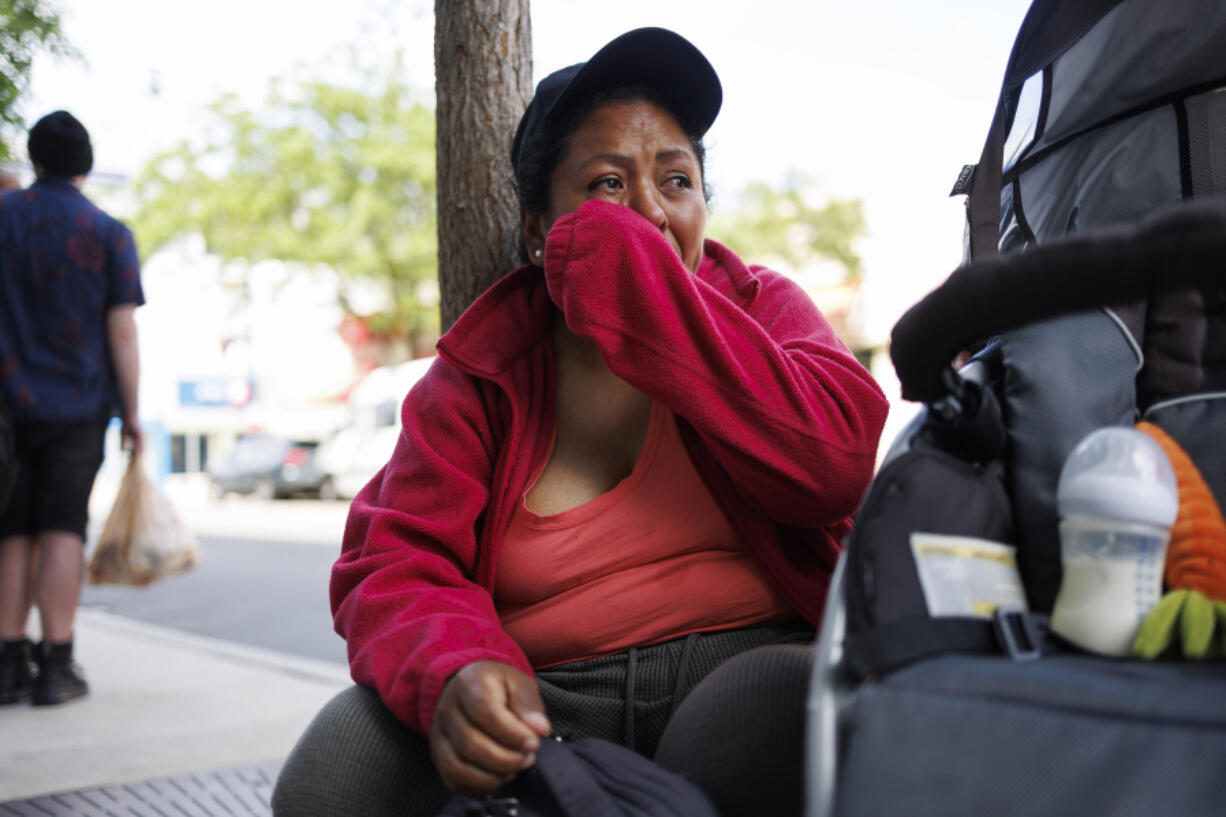 Jessica Juma, from Ecuador, cries while sitting on the street where her husband, Angel Mashiant, went missing on May 25 near a Mariano&Ccedil;&fnof;&Ugrave;s in Chicago&rsquo;s Lakeview neighborhood, on June 3, 2024. (Armando L.