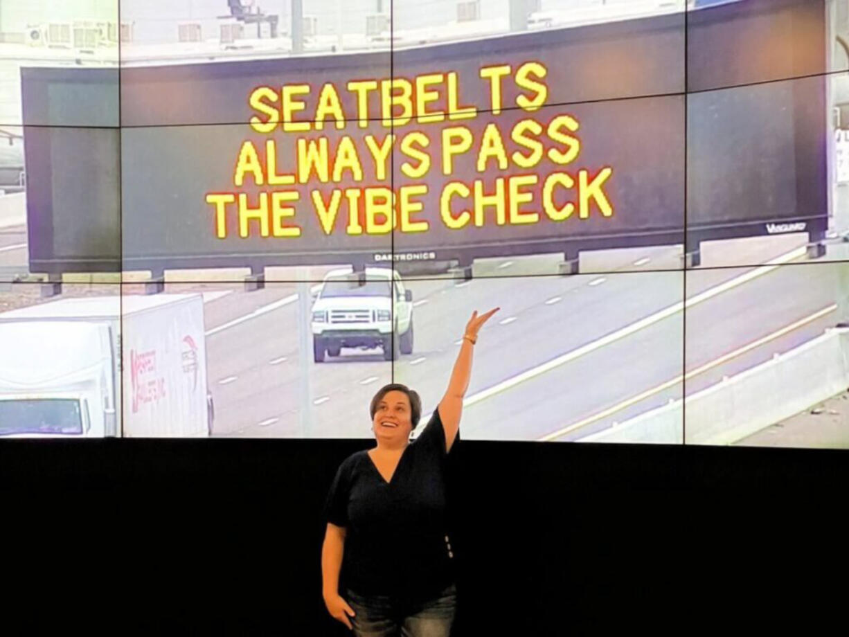 Elise Riker, a marketing professor at Arizona State University, shows off her winning contest entry for a state highway safety message displayed last fall. States are using more creative message to get attention, but federal authorities have warned that confusing messages could actually increase crashes.