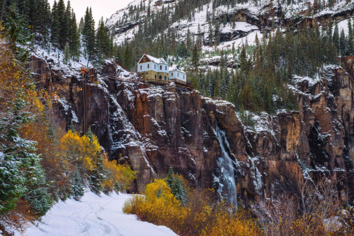 Shown in autumn, Bridal Veil Falls sits with an old hydroelectric plant perched at its top in Telluride, Colo.