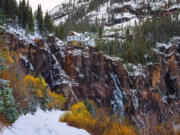 Shown in autumn, Bridal Veil Falls sits with an old hydroelectric plant perched at its top in Telluride, Colo.