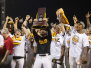 Tennessee coach Tony Vitello, center, hoists the championship trophy following his team's 6-5 victory against Texas A&amp;M in Game 3 of the NCAA College World Series baseball finals in Omaha, Neb., Monday, June 24, 2024. (AP Photo/Rebecca S.