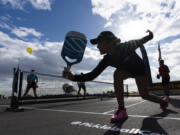 Catherine Parenteau returns the ball during a pickle ball match in Carson, Calif. The health benefits of spending time in nature have long been established, and exercise in general improves physical and mental well-being.