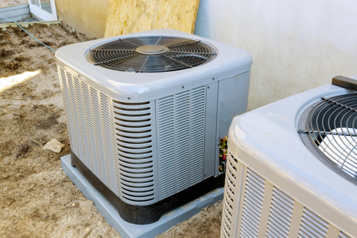 Outdoor air conditioning units require a certain amount of clearance space from plants and obstructions to work correctly.