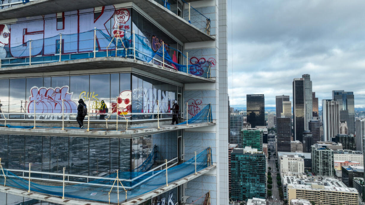 Taggers have graffitied what appears to be more than 25 stories of a downtown Los Angeles skyscraper that&rsquo;s been sitting dormant for several years. Construction on Oceanwide Plaza, a $1 billion mixed-use retail and luxury apartments project with three towering unfinished structures, stalled in January 2019 after the Beijing-based developer lacked the funds to complete it.