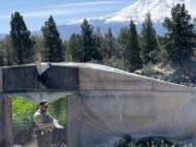 A Siskiyou County sheriff&rsquo;s deputy writes a violation notice at an unlicensed cannabis farm where illegal pesticides had been used. All five farms searched that day showed evidence illegal pesticides had been burned to fumigate plants. (Paige St.