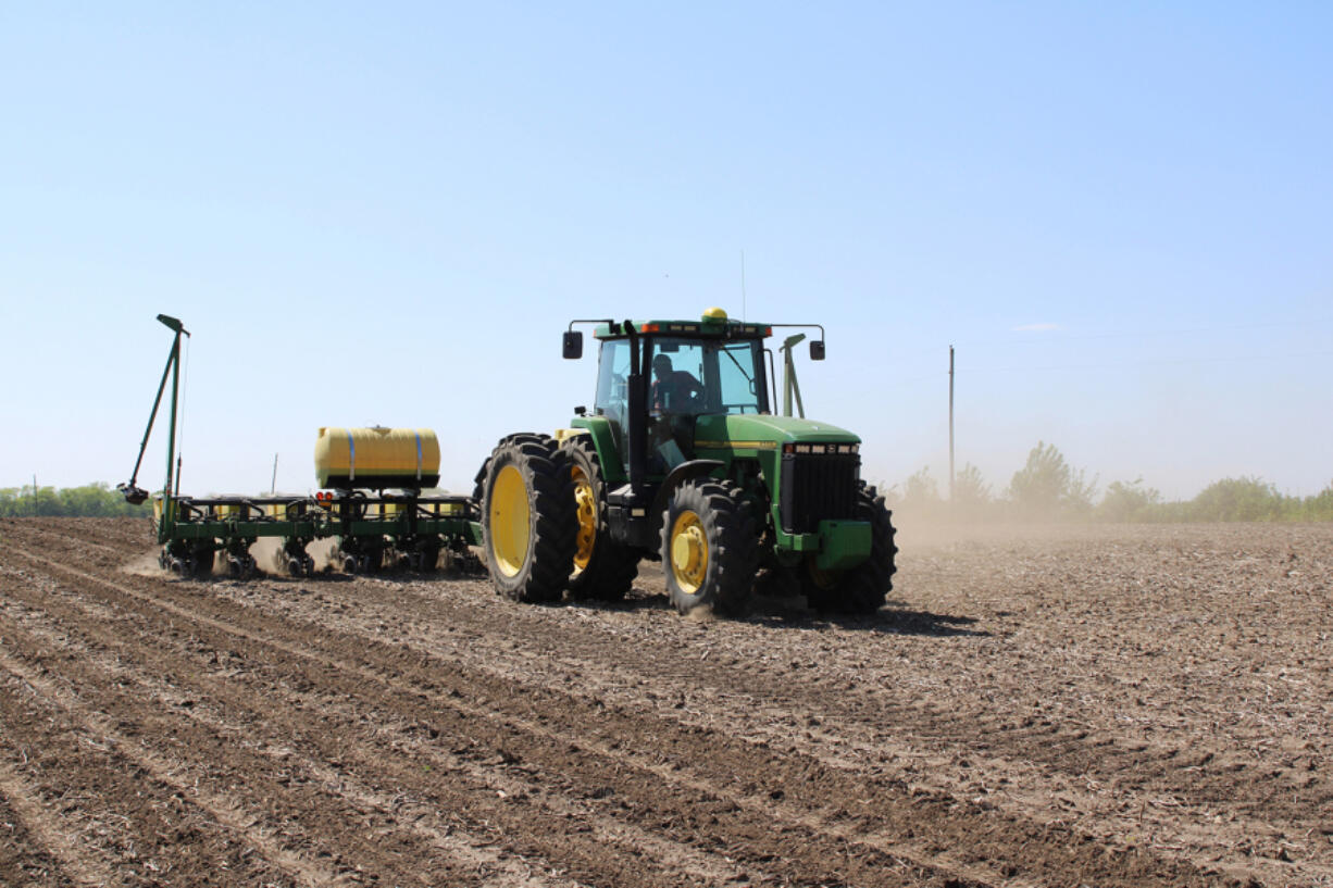 Josh Kruse plants corn near Boone, Iowa, on May 17, 2024. Kruse runs the 500-acre farm with brother-in-law Jason Haglund, who grew up there and is a mental health advocate.