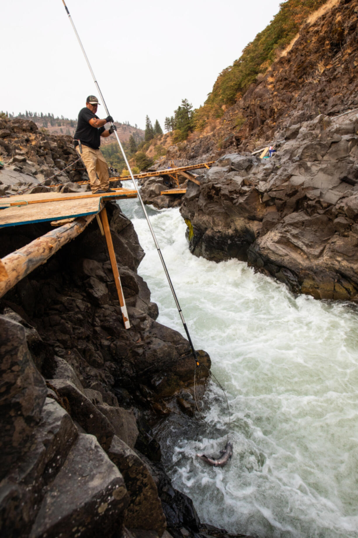 A Yakama tribal fisherman on a traditional fishing platform on the Klickitat River.