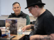 Secretary of State Steve Hobbs, left, plays Dungeons &amp; Dragons with Jefferson Dunlap of Wizards of the Coast at the Camas Public Library on Monday afternoon. The role-playing game kit was donated through the Washington State Library.