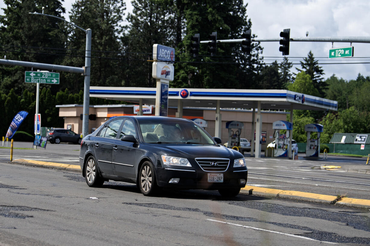 A motorist navigates rough road conditions along Northeast 112th Avenue, one of the busiest corridors in Vancouver, carrying 40,000 vehicles daily.