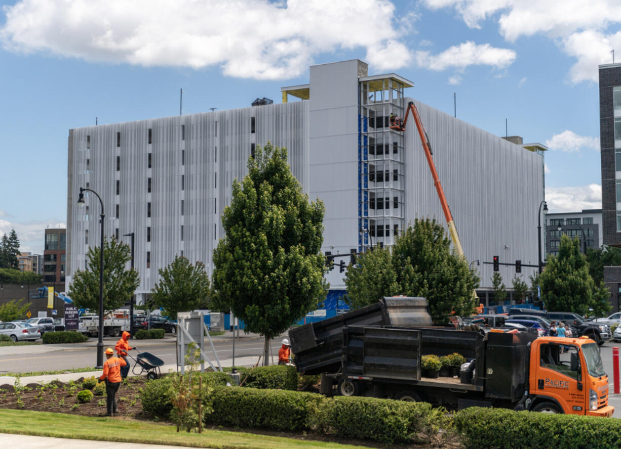 Work continues on a new parking structure near the waterfront in Vancouver. The Vancouver City Council is considering new taxes, including a commercial parking tax, to help cover a projected budget shortfall.