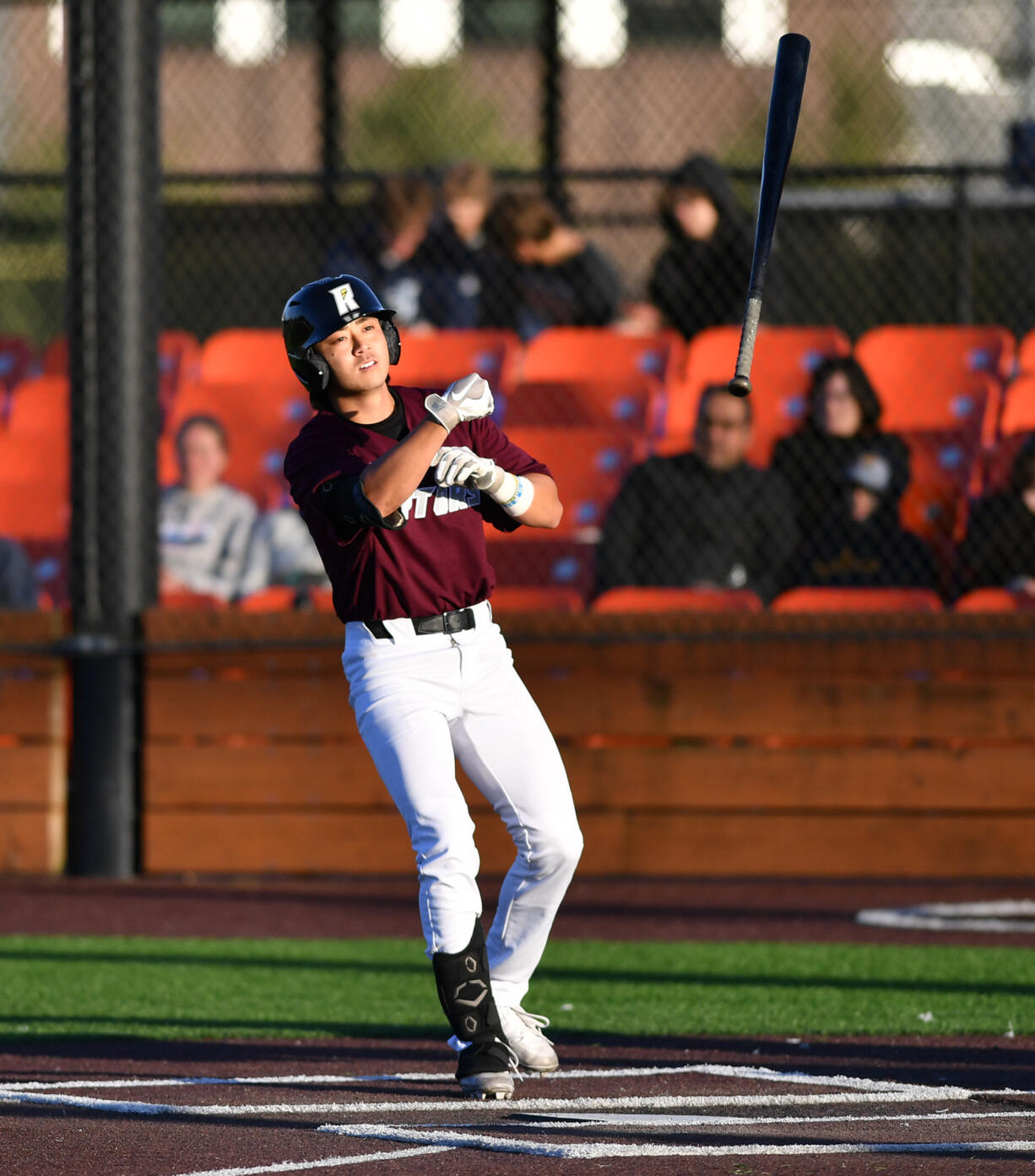 Ridgefield's Taylor Takata tosses his bat after drawing a walk Tuesday June 11, 2024, during the Raptors’ 10-0 win against Yakima Valley Pippins at the Ridgefield Outdoor Recreation Complex.