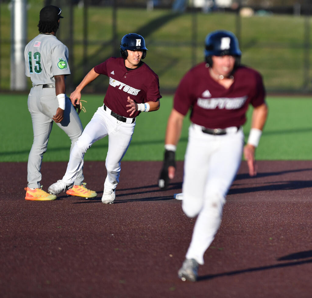 Ridgefield's Taylor Takata, left, and Kyle Memarian run the bases June 11, 2024,during the Raptors’ 10-0 win against Yakima Valley Pippins at the Ridgefield Outdoor Recreation Complex.