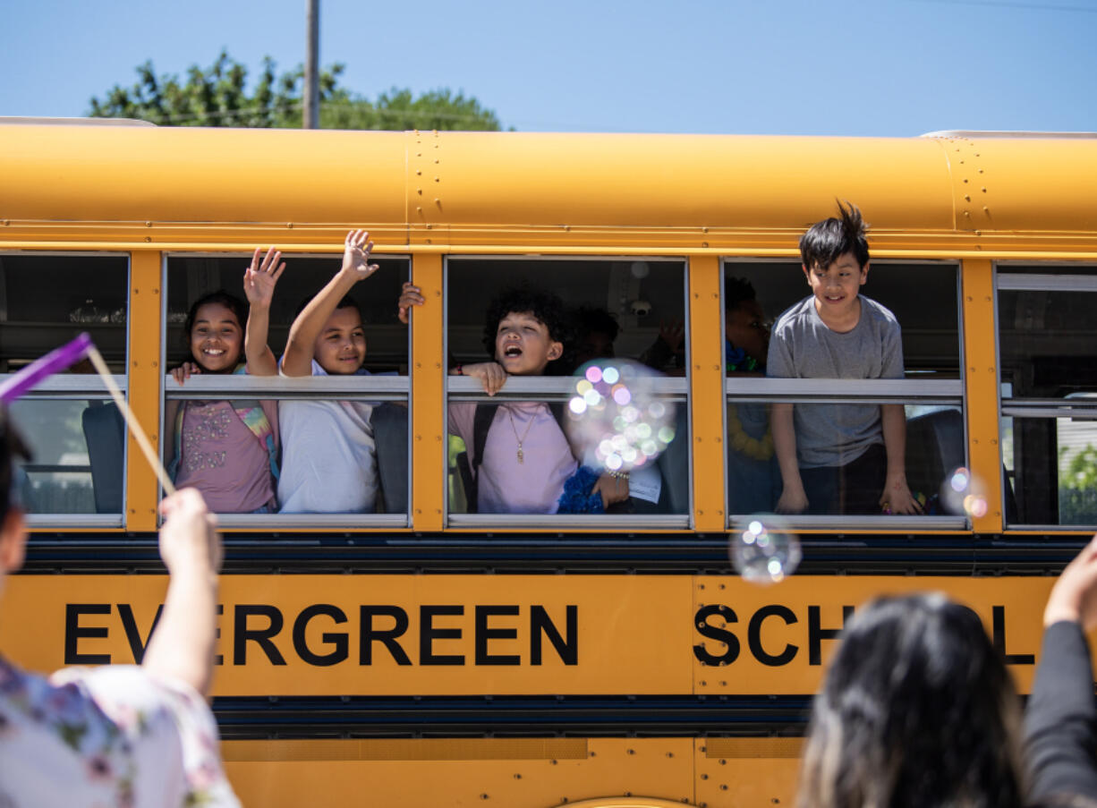 Burton Elementary School students wave goodbye at faculty and staff Tuesday in Vancouver on the last day of school in Evergreen Public Schools.