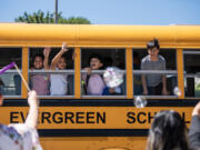 Burton Elementary School students wave goodbye at faculty and staff Tuesday in Vancouver on the last day of school in Evergreen Public Schools.