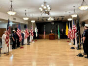 Sea Scouts and Emblem Club members observe while the exalted ruler of the Elks calls the lodge to attention to recite the Pledge of Allegiance.