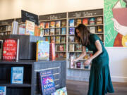 Eden Wade arranges books on a display. Her bookstore, Autumn Leaf Books, is the latest of six Clark County stores to open since 2021.