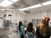 Tour attendees look around a trauma room at the new emergency room at PeaceHealth Southwest Medical Center in Vancouver.