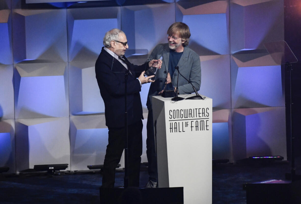 Inductee Donald Fagan, left, of Steely Dan, receives his award from Trey Anastasio at the Songwriters Hall of Fame Induction and Awards Gala on June 13.