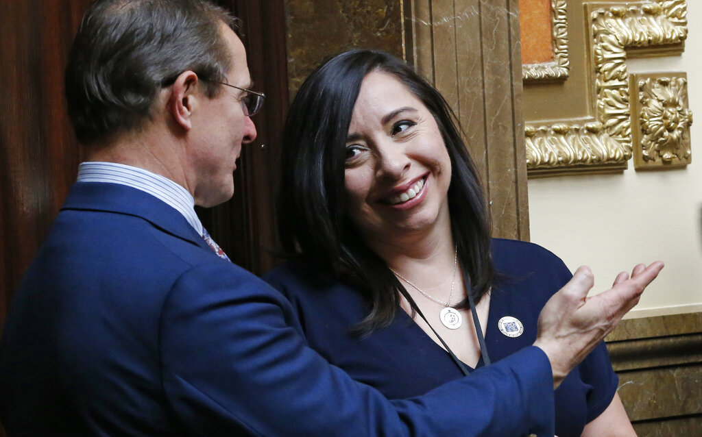 Rep. Angela Romero, D-Salt Lake City, speaks with Rep. Ken Ivory, R-West Jordan,on the House floor Tuesday, Feb. 26, 2019, in Salt Lake City. A proposal to ban most underage marriage in Utah has cleared its first hurdle with support from women who have left polygamous groups. Romero said Monday that all unions involving people under 18 are associated with higher rates of divorce and lower levels of education. Her bill would ban all marriage for 15-year-olds, though older teens could wed with a judge's permission.