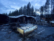 FILE - In this Dec. 4, 2018, file photo, a bed rests outside Cypress Meadows Post-Acute, a nursing home leveled by the Camp Fire, in Paradise, Calif. California state and local officials are encouraging rebuilding in areas destroyed by wildfires at a time when people should be redirected away from those areas if the state wants to reduce the economic and human impact of increasingly destructive wildfires, according to a report published Thursday, June 10, 2021.