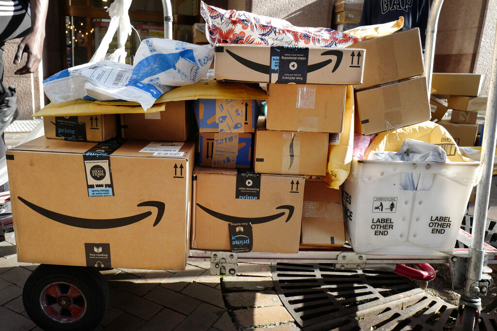 FILE - In this Oct. 10, 2018, file photo Amazon Prime boxes are loaded on a cart for delivery in New York. The nation’s major shipping companies are in the best shape to get holiday shoppers’ packages delivered on time since the start of the pandemic, suggesting a return to normalcy.