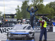 Shane van Gisbergen celebrates after winning the NASCAR Xfinity Series auto race at Portland International Raceway on Saturday, June 1, 2024, in Portland, Ore.