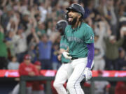 Seattle Mariners' J.P. Crawford reacts after hitting a grand slam off Los Angeles Angels starting pitcher Reid Detmers during the fourth inning of a baseball game Saturday, June 1, 2024, in Seattle.