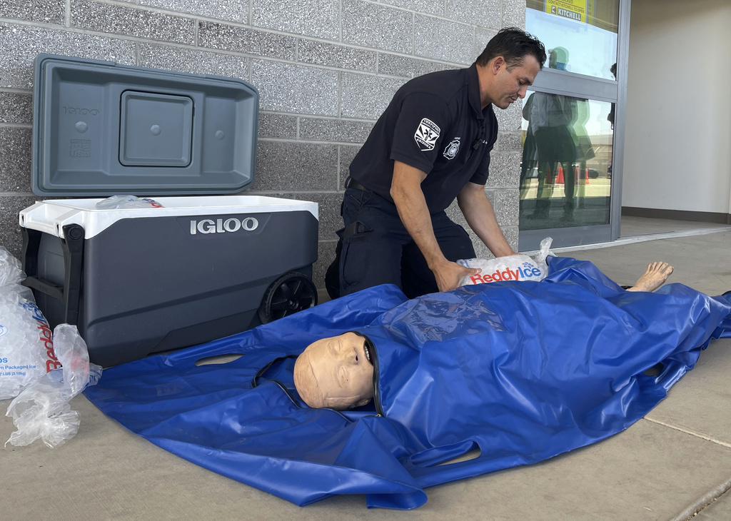 Phoenix Fire Capt. John Prato demonstrates a new protocol that the fire department in America’s hottest big city is adopting as the West braces for the first heat wave of the summer season, Monday, June 3, 2024, in Phoenix. The cold water immersion therapy already used by hospitals in the area will also now be used by Phoenix fire and paramedics personnel on every patient they encounter this season with signs of heat stroke.