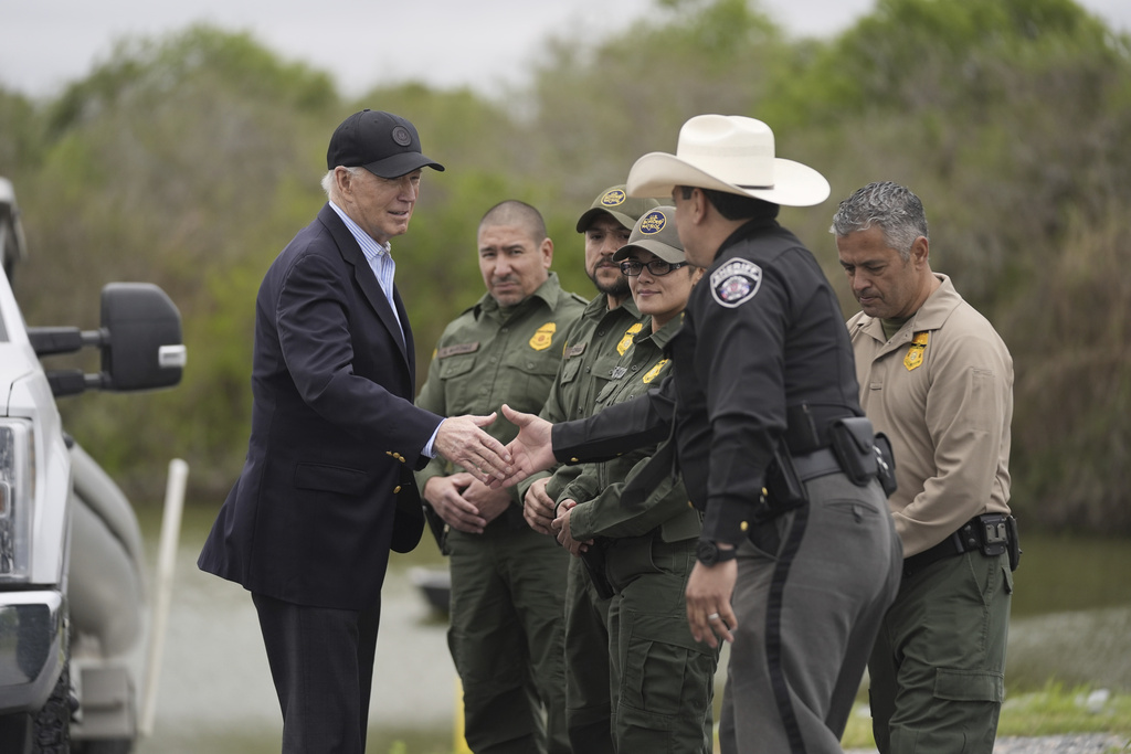 FILE - President Joe Biden talks with the U.S. Border Patrol and local officials, as he looks over the southern border, Feb. 29, 2024, in Brownsville, Texas, along the Rio Grande. Biden's migration order aims to shut down asylum requests at US-Mexico border if illegal crossings average 2,500 per day.