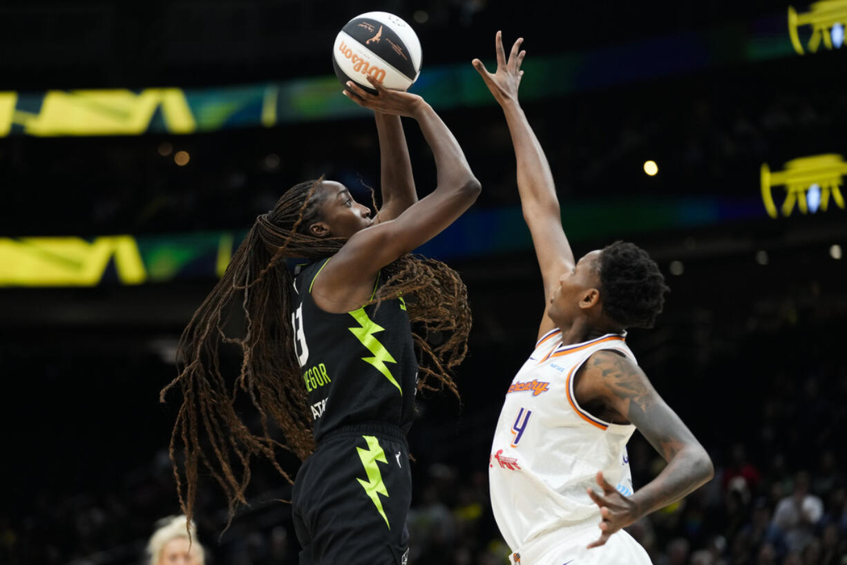 Seattle Storm center Ezi Magbegor, left, shoots against Phoenix Mercury forward Natasha Mack during the first half of a WNBA basketball game Tuesday, June 4, 2024, in Seattle.