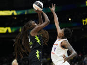 Seattle Storm center Ezi Magbegor, left, shoots against Phoenix Mercury forward Natasha Mack during the first half of a WNBA basketball game Tuesday, June 4, 2024, in Seattle.